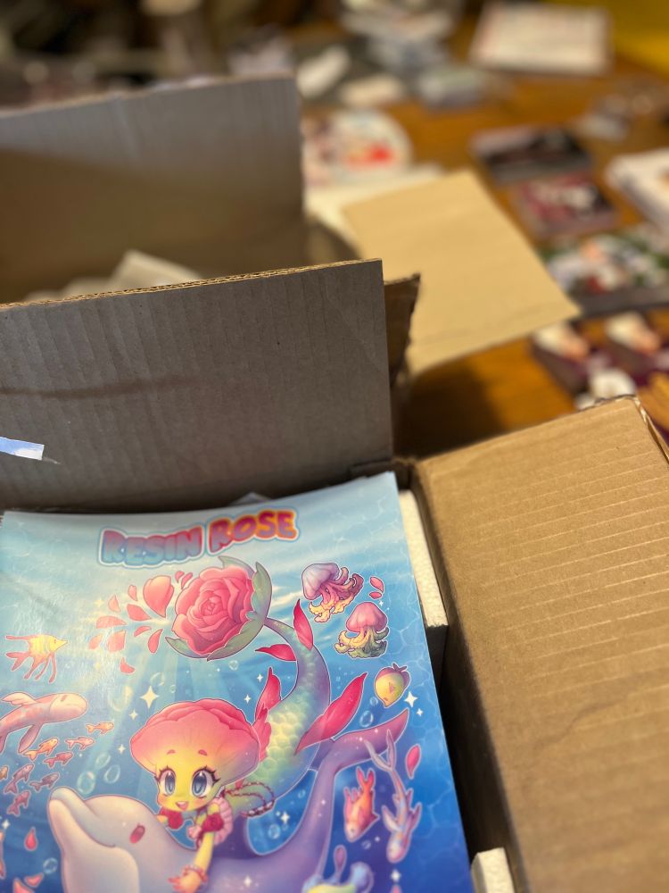 Round Two: Paper goods. This includes the limited edition coloring book in the foreground. In the background is a long row of promotional materials from sponsors.
