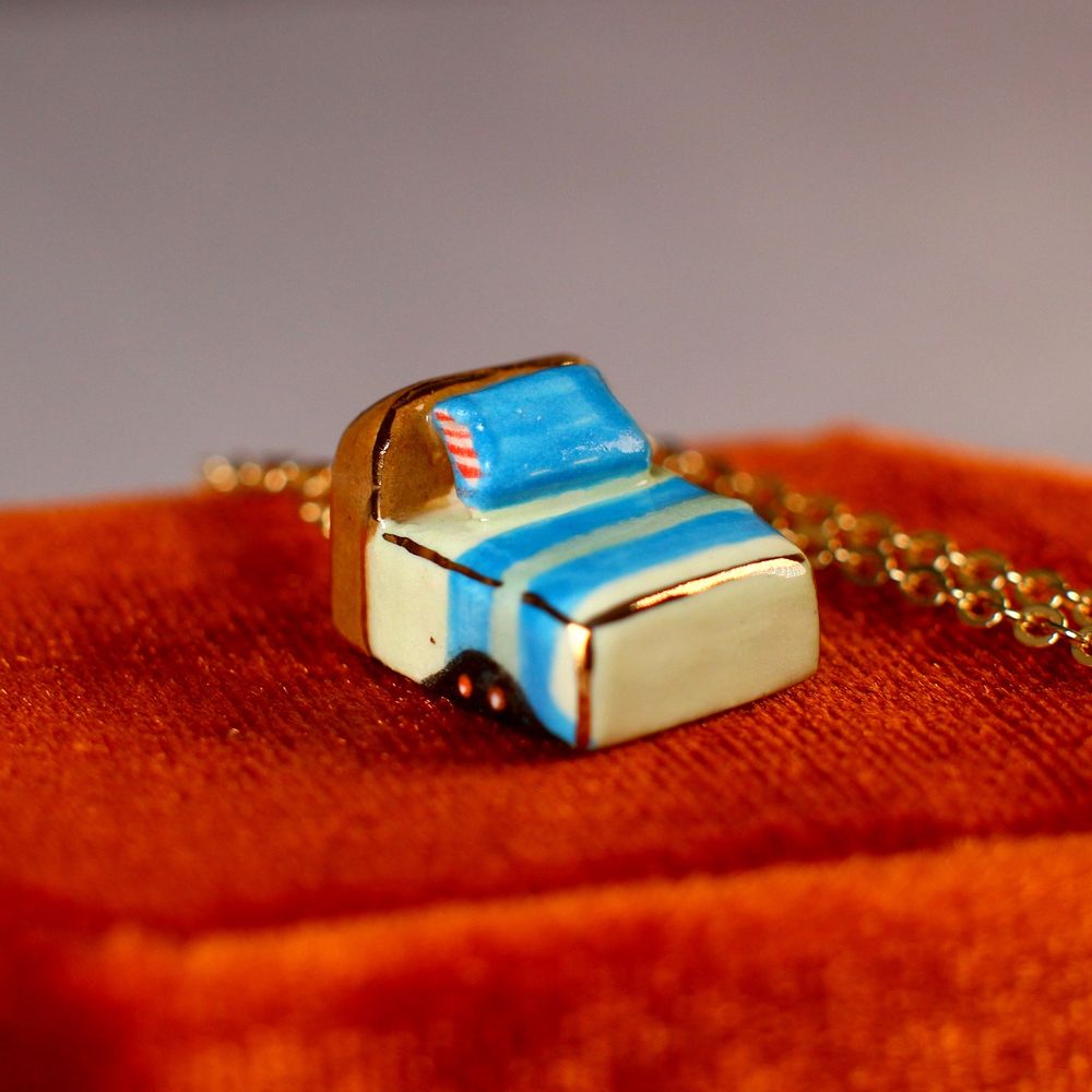 Ceramic bed pendant with the glowing eyes of monsters peeking from underneath.