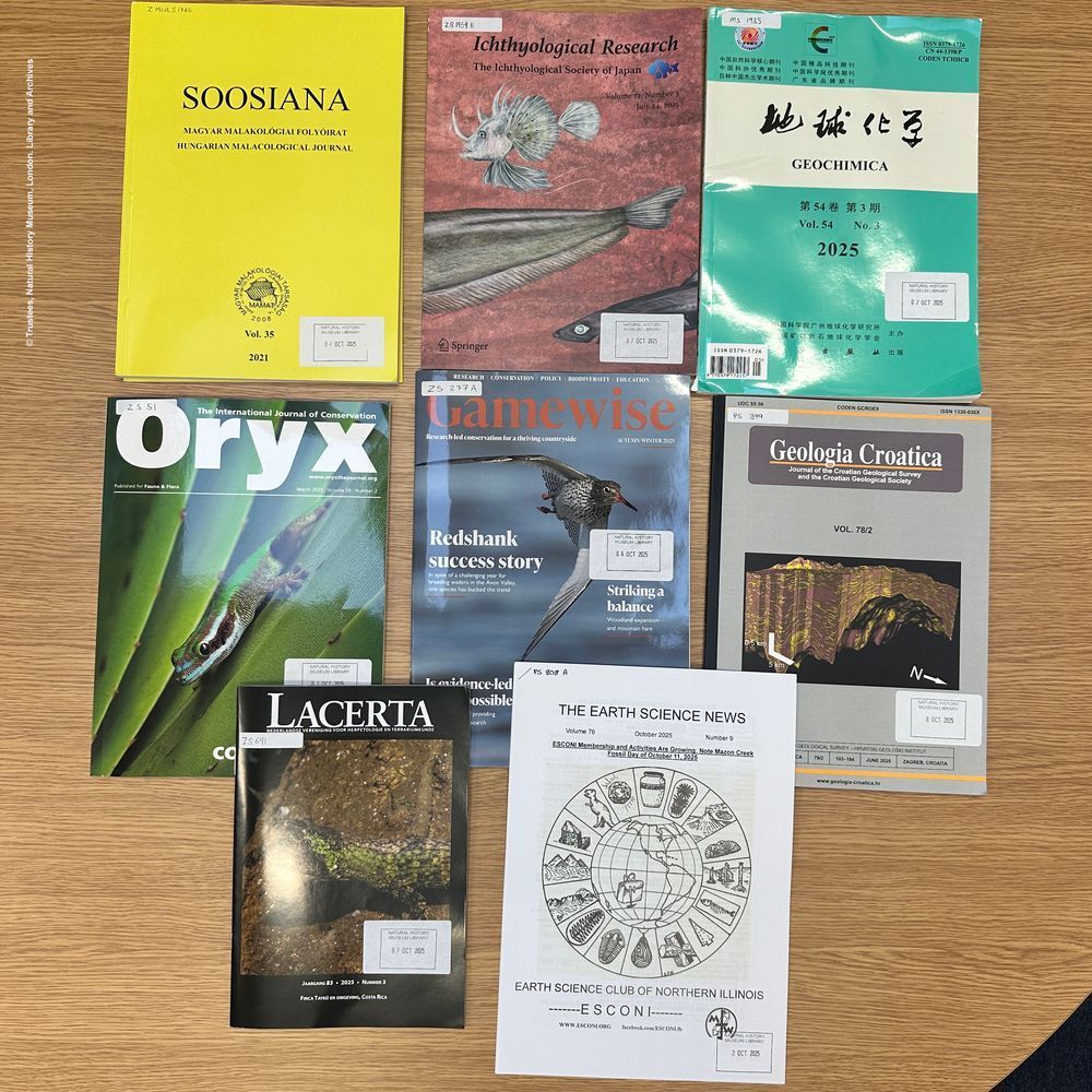 Eight journals related to natural history and science displayed on a table.