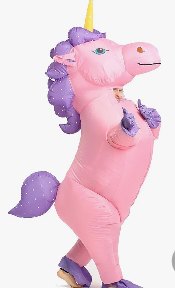 A blown up inflatable costume of a pink unicorn with purple hooves, tail, and mane.