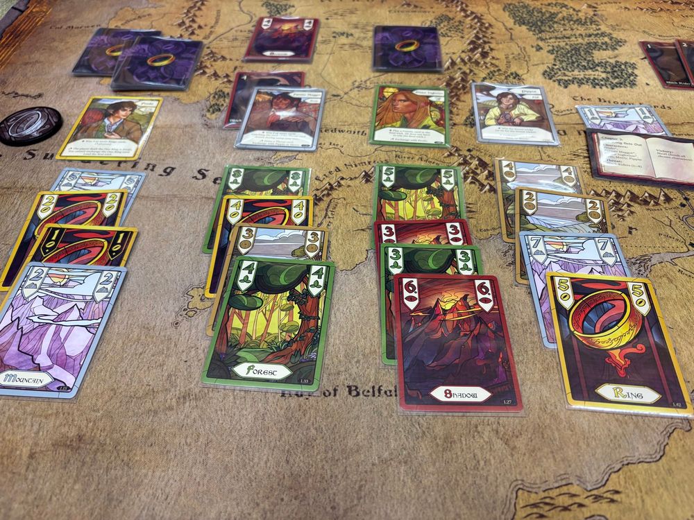 Drawing the 4 of Forests should make Maggot’s chances of getting his 2nd trick a lot easier in Chapter 3 of The Fellowship of the Ring TTG. However, I can’t lose sight of the fact that Frodo hasn’t acquired any of his Ring cards yet and Pippin holding the 5 of Rings might complicate things 