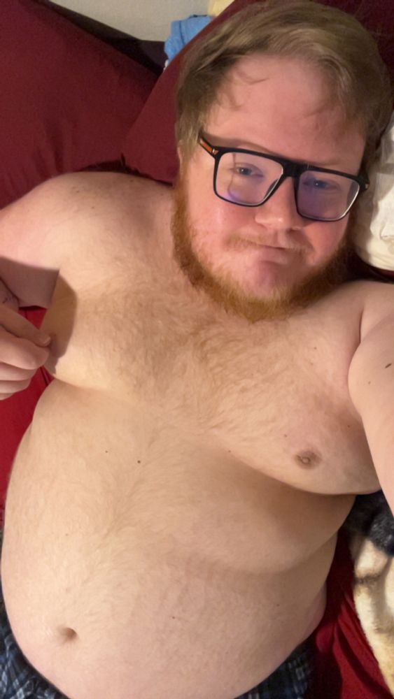 Laying in bed shirtless, pinching my nipple 