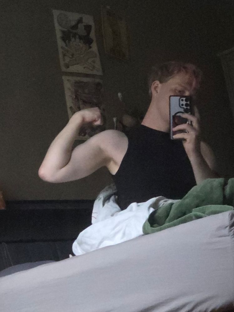 sadie sitting in bed flexing her bicep. wait is she jacked