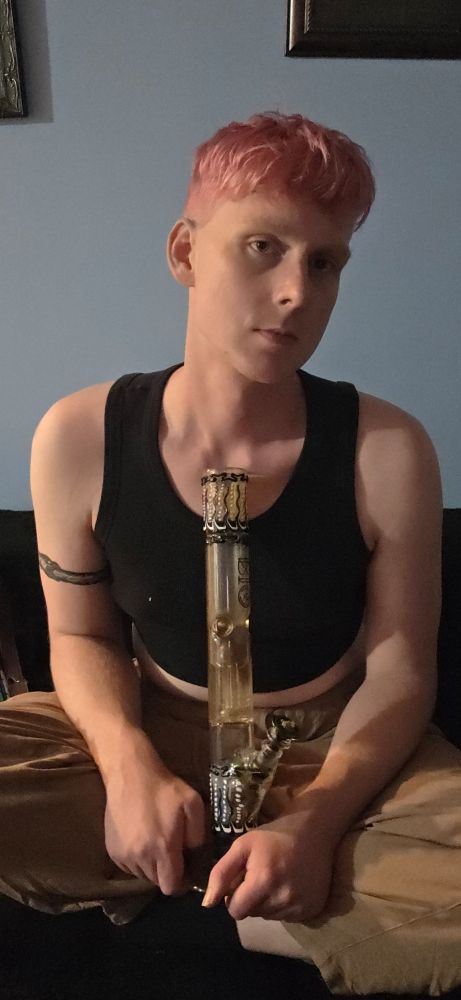 sadie sitting cross-legged with a big bong in her lap