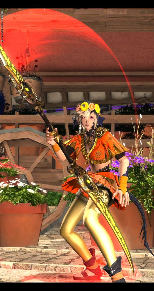 An au ra from FFXIV wearing a bright orange and yellow outfit including a flower crown
