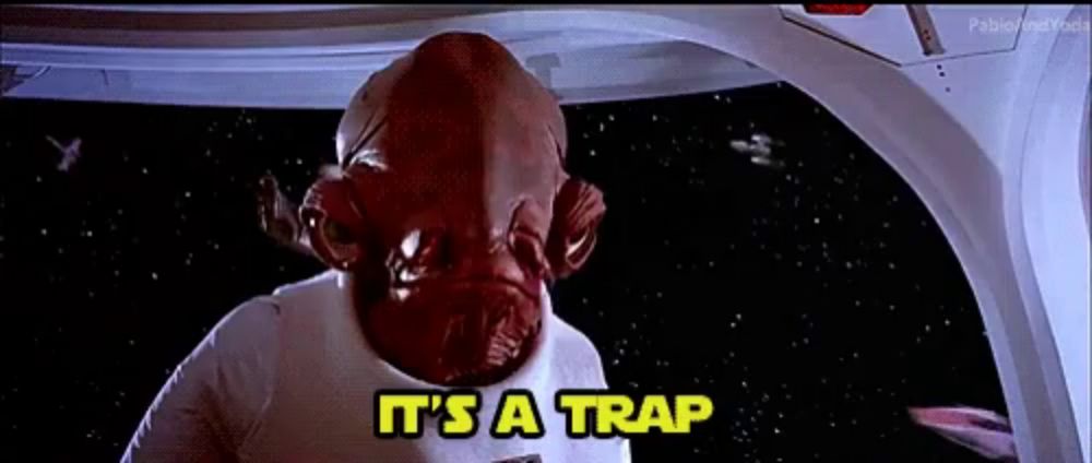 a man with a red face is standing in a space ship and saying it 's a trap .