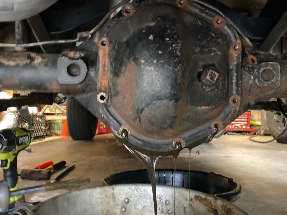 Old gear oil draining from a differential. 