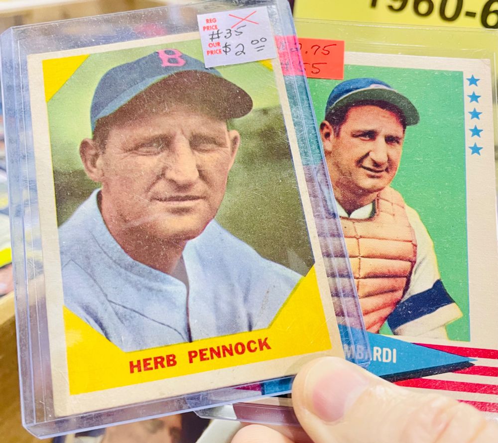 Baseball cards of Herb Pennock and Ernie Lombardi. They are squinting in similar ways at the camera.