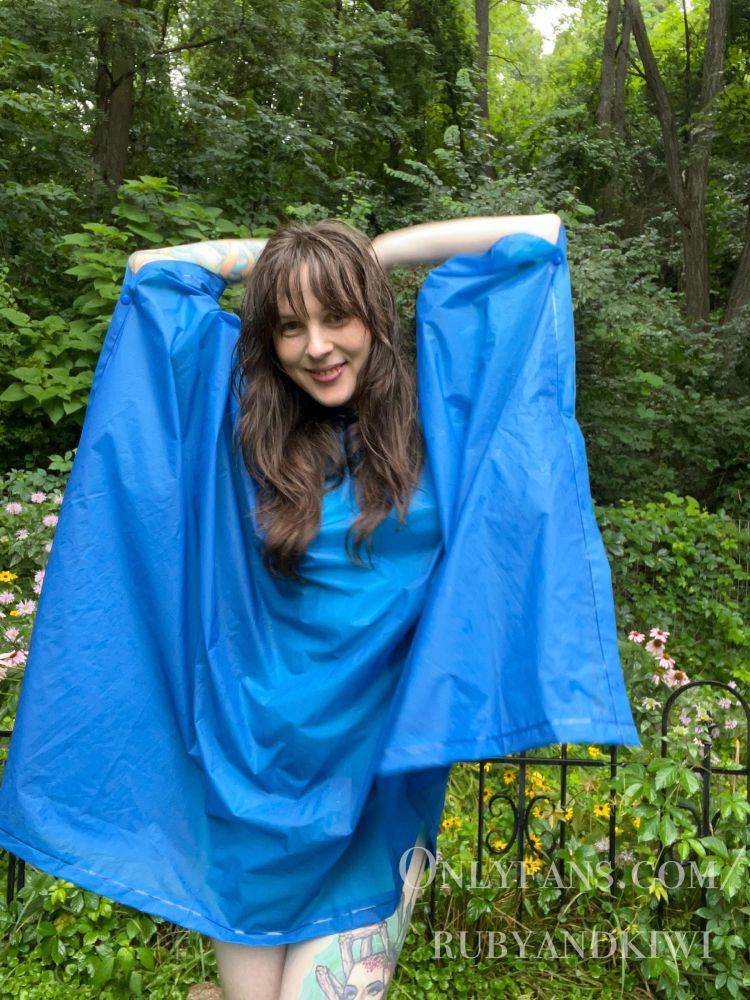 Kiwi wears a blue poncho with the promise of nothing underneath. Text says “onlyfans.com/rubyandkiwi”
