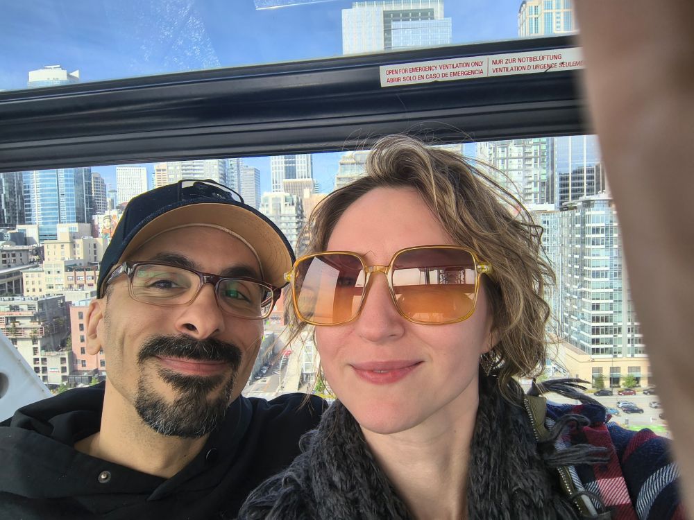 Chris and Steph on the Seattle ferris wheel with a view of the city skyline behind us.
