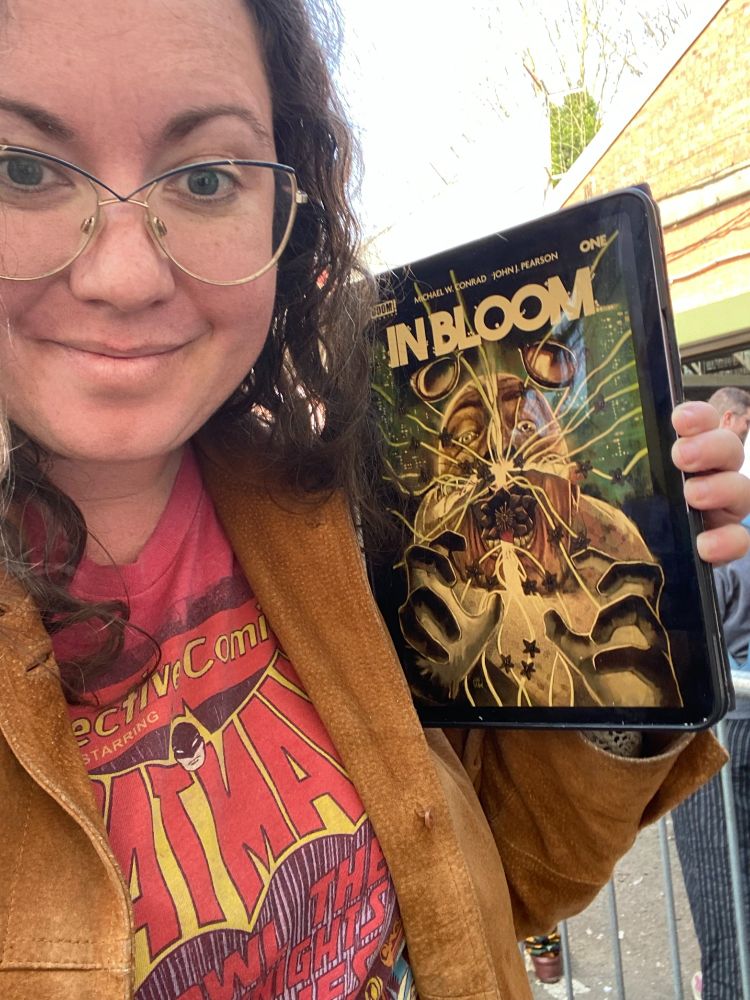 Meghan holds issue 1 of IN BLOOM on her iPad.