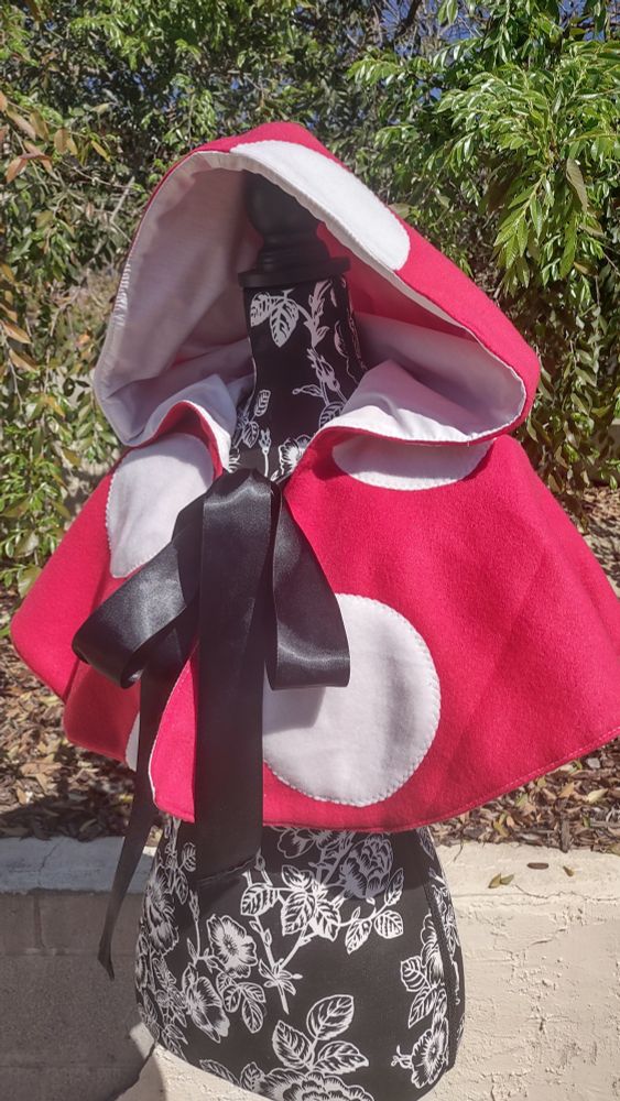 Red and white spotted mushroom cape.