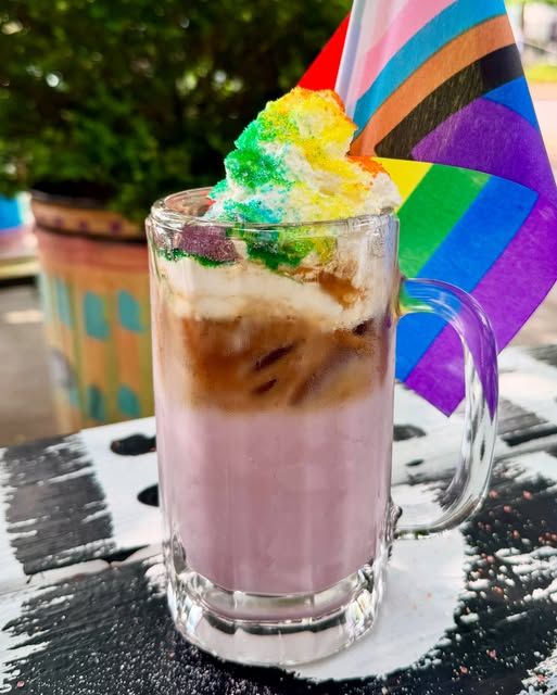 Loud n Proud Smoothie drink, pink drink with whipped cream and rainbow sprinkles.