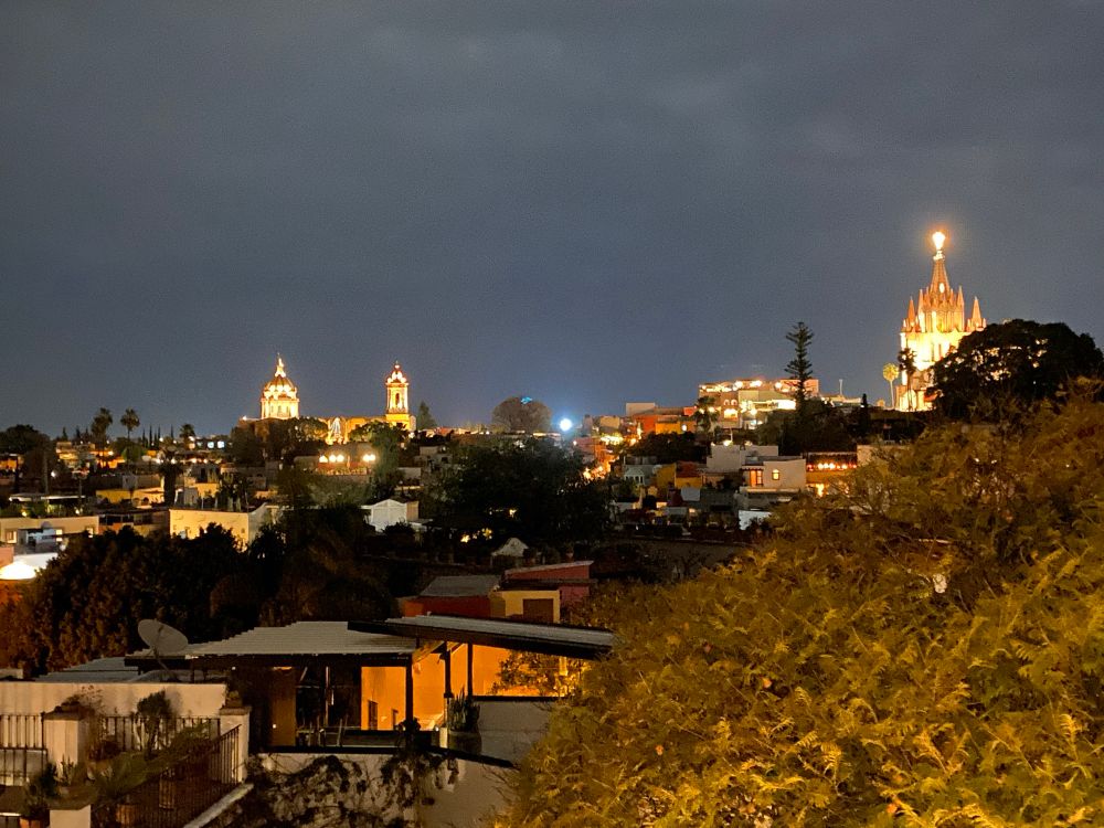 Sam Miguel at night- a beautiful hillside with warm lights, the cathedral all lit up. 