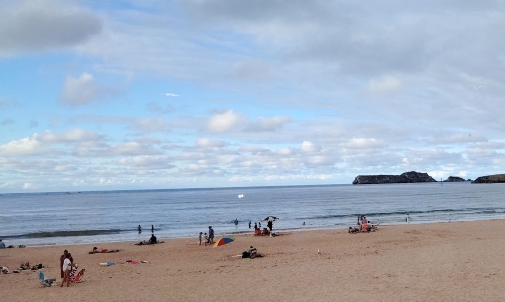 Random picture of one of the beaches at Suances. Golden sand, blue sea and blue/grey sky. 