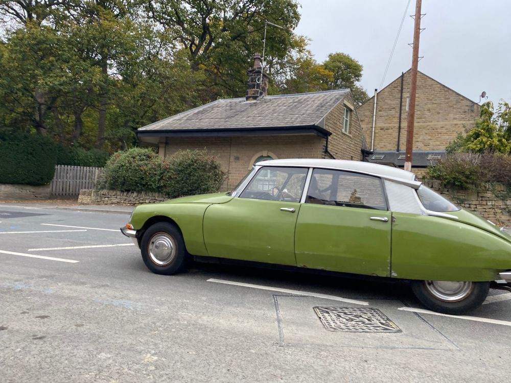 Photograph of a cool car. Two-tone green and cream. A Citroën DS? 