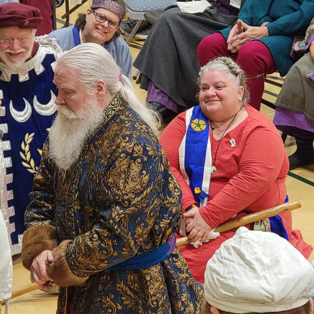 True Thomas the Storyteller, kneeling before the king, and me beaming and crying happy tears, sitting on the floor behind him