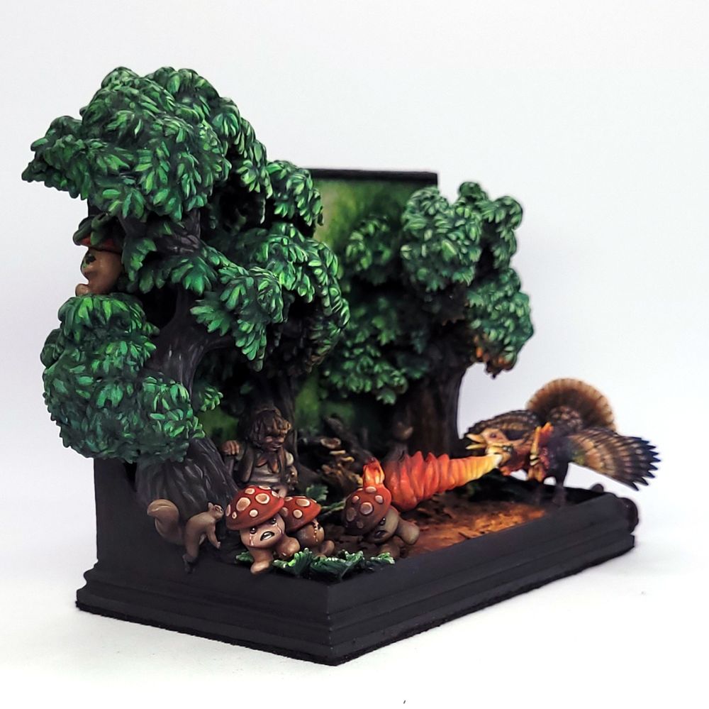 A diorama of a forest scene. A three headed bird is breathing a jet of flame and roasting the everloving heck out of three, terrified, adorable little mushroom people. One is actively trying to climb out of the diorama