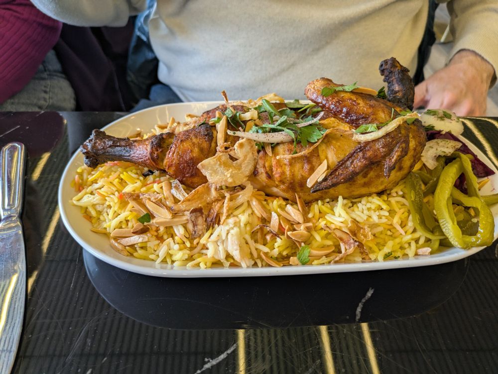 Paul's chicken mandi. It's half a grilled chicken, laid on a bed of seasoned rice, and topped with toasted almonds. He was making the happiest noises while eating -- the best testimonial!