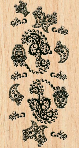 Unusual Paisley patterns etched into wood: The wards around the Paisley Foundation's front doors. They appear to be an odd design combining beak-like paisley, strange curling leaves with circles and half moons cut out of it, and various combinations of these elements in a dark green ink on a woodgrain surface.