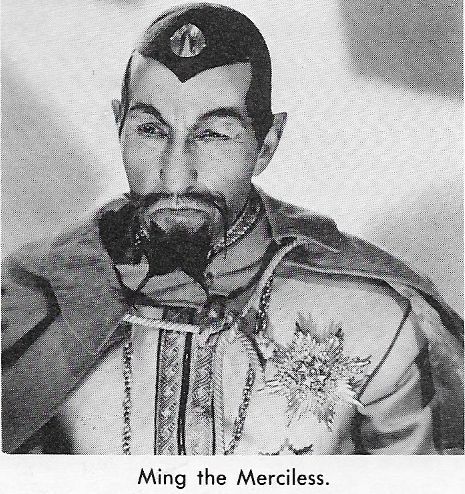 Black and white photo of Charles Middleton as Emperor Ming, from Flash Gordon. He has a black skullcap, pointed ears, a forked beard, a cape, and a tunic with a large medal