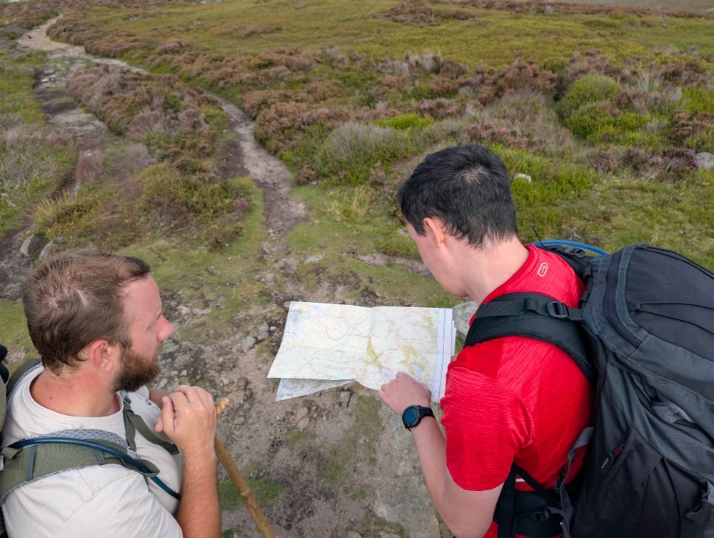 Two confused guys looking at an OS map, soon to realise we're off trail