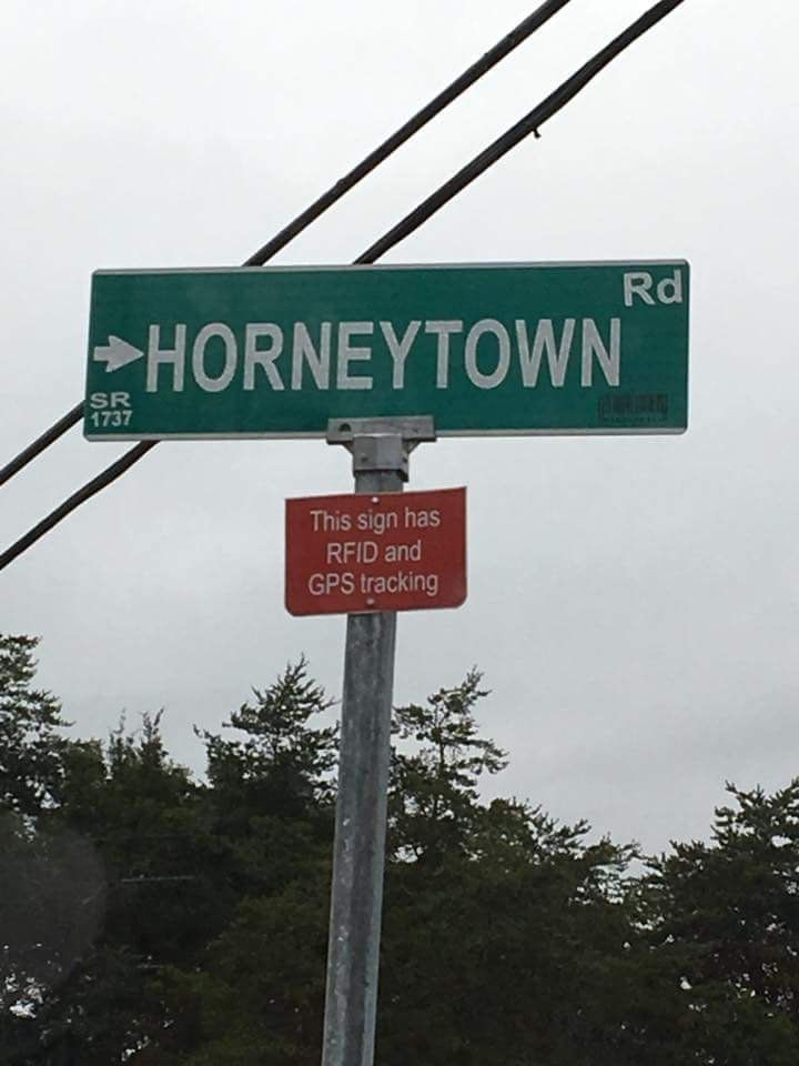 Street sign for Horneytown Rd. Under is a second sign that says "This sign has RFID and GPS tracking"