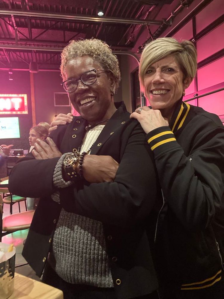 Photo of two women smiling and standing together
