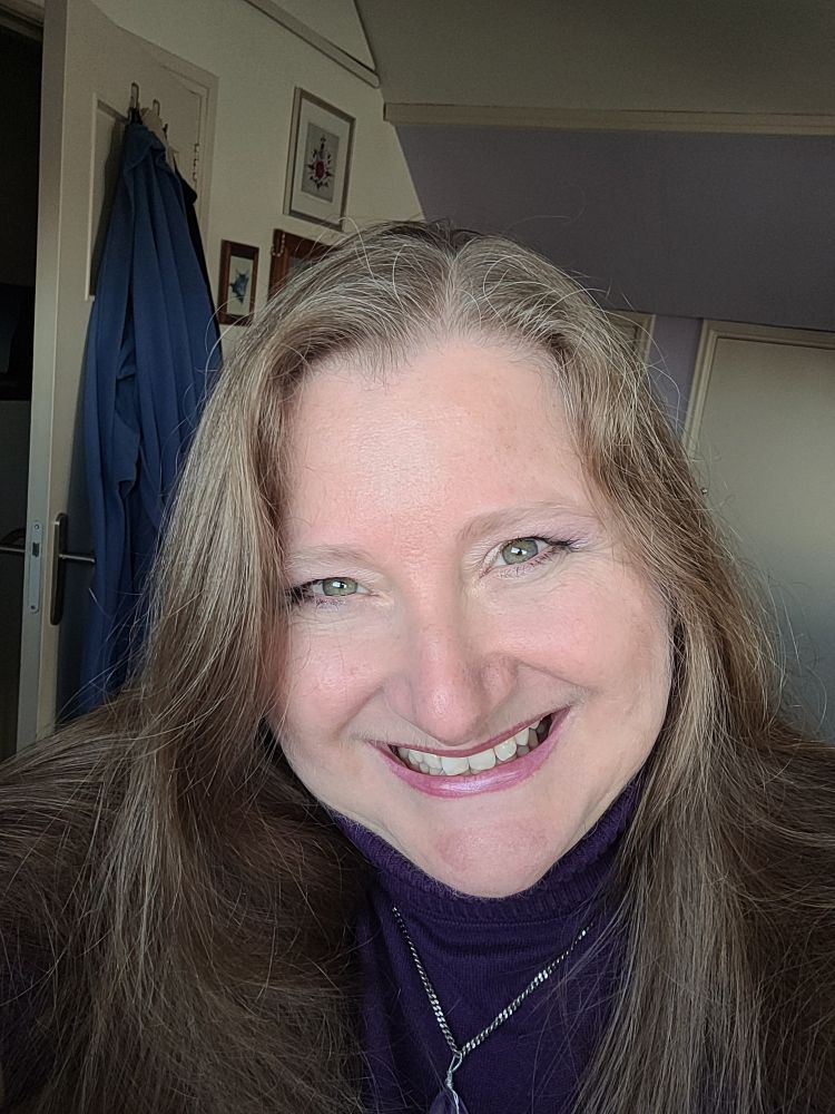 Me. Long dark blonde haired woman smiling at the camera. 