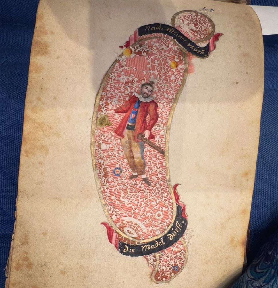 sausage made of red ribbon with a lace cover, featuring a fancy little guy and a caption saying “The girls thirst / for my wurst”