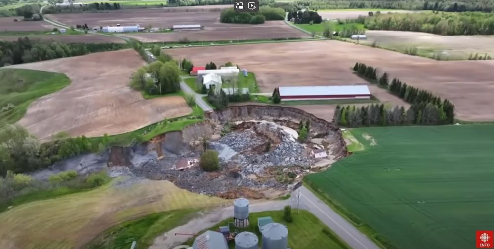 A drone image of the site of the 21 May 2025 quick clay landslide at Sainte Monique in Canada. Still from a drobe video posted to Youtube by Radio-Canada Info.