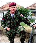 Brigadier Adrian Freer of the Parachute Regiment, posing in Kosovo with a distinctively non-NATO blue and white striped undershirt that he gained from Major-General Vladimir Rybkin whilst they were sharing vodka and whisky, and trying to prevent NATO and Russian forces from opening fire on each other. 
