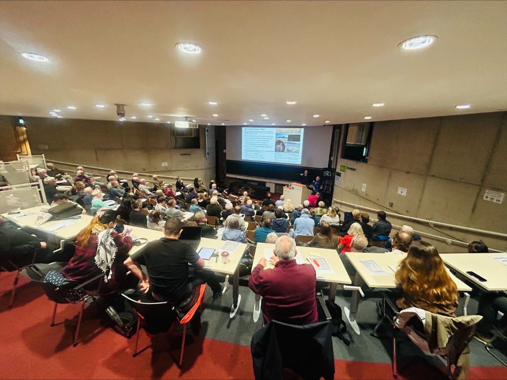 A group of people sitting in an auditorium. 