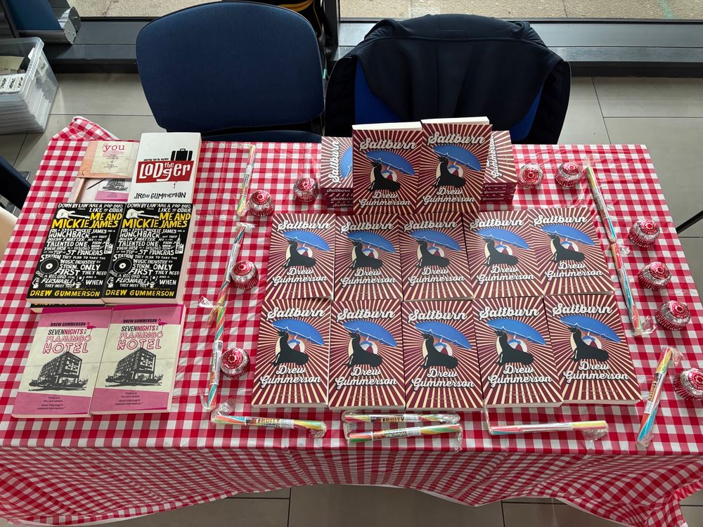 A load of my books on a checked table cloth. 
