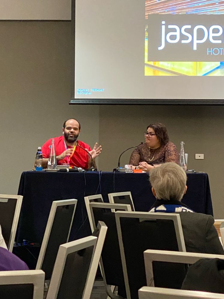 Cienan Muir and Kimmie Lovegrove sitting at a table.