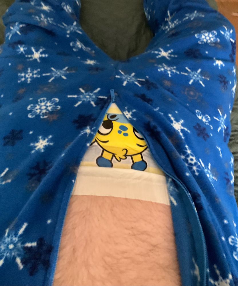 Diaper peeking from behind footed pajamas