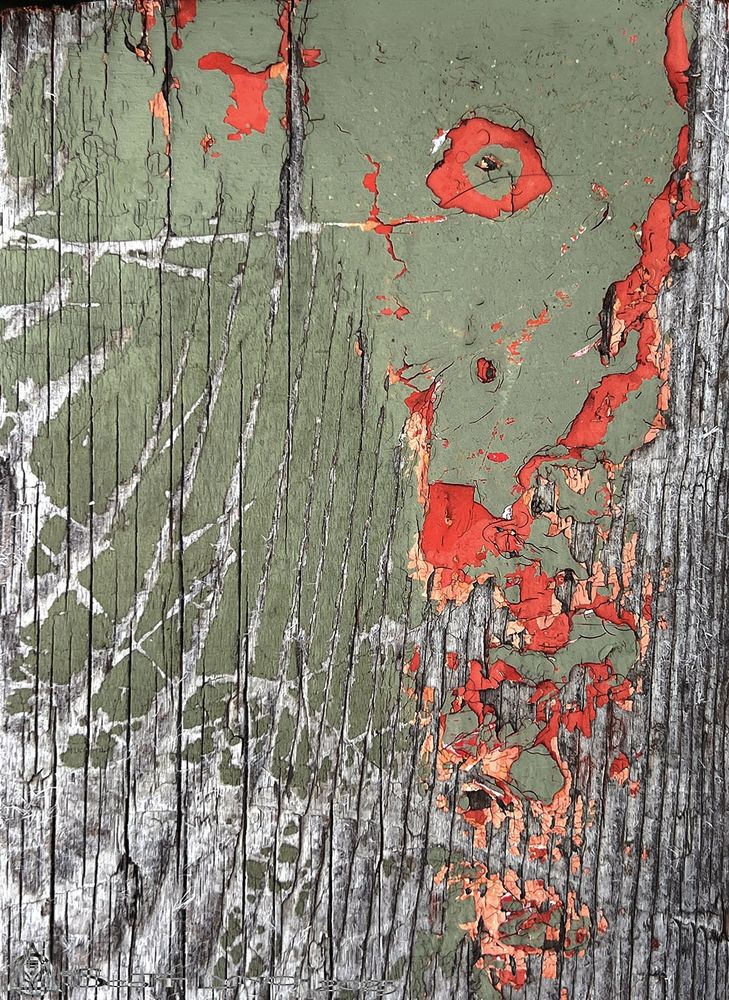 An old wooden seat on some old tired bleachers.