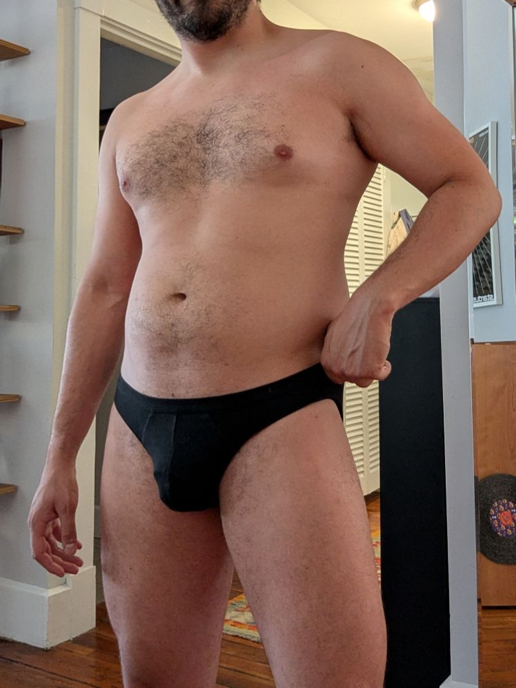 Headless torso of a man in black briefs