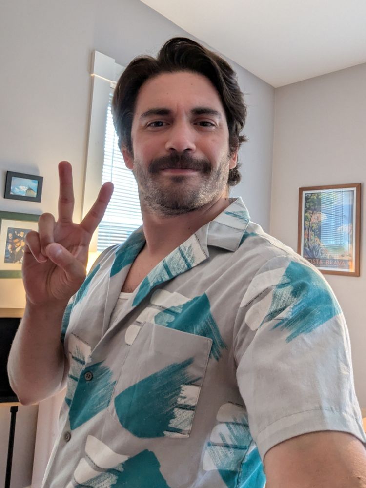 A guy in a stache takes a selfie