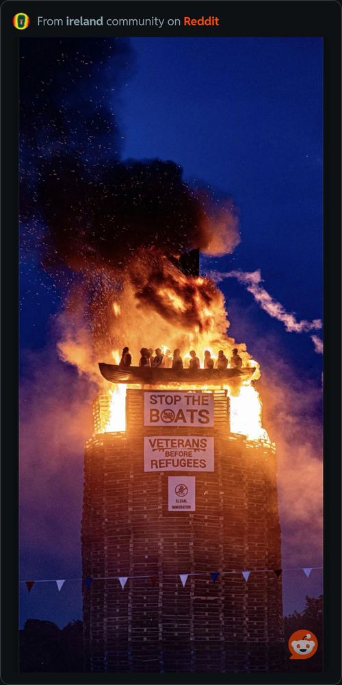 À loyalist bonfire in moygashel where à boatful of refugees/migrants are being burnt in effigy. There is a slogan Stop the boats. 