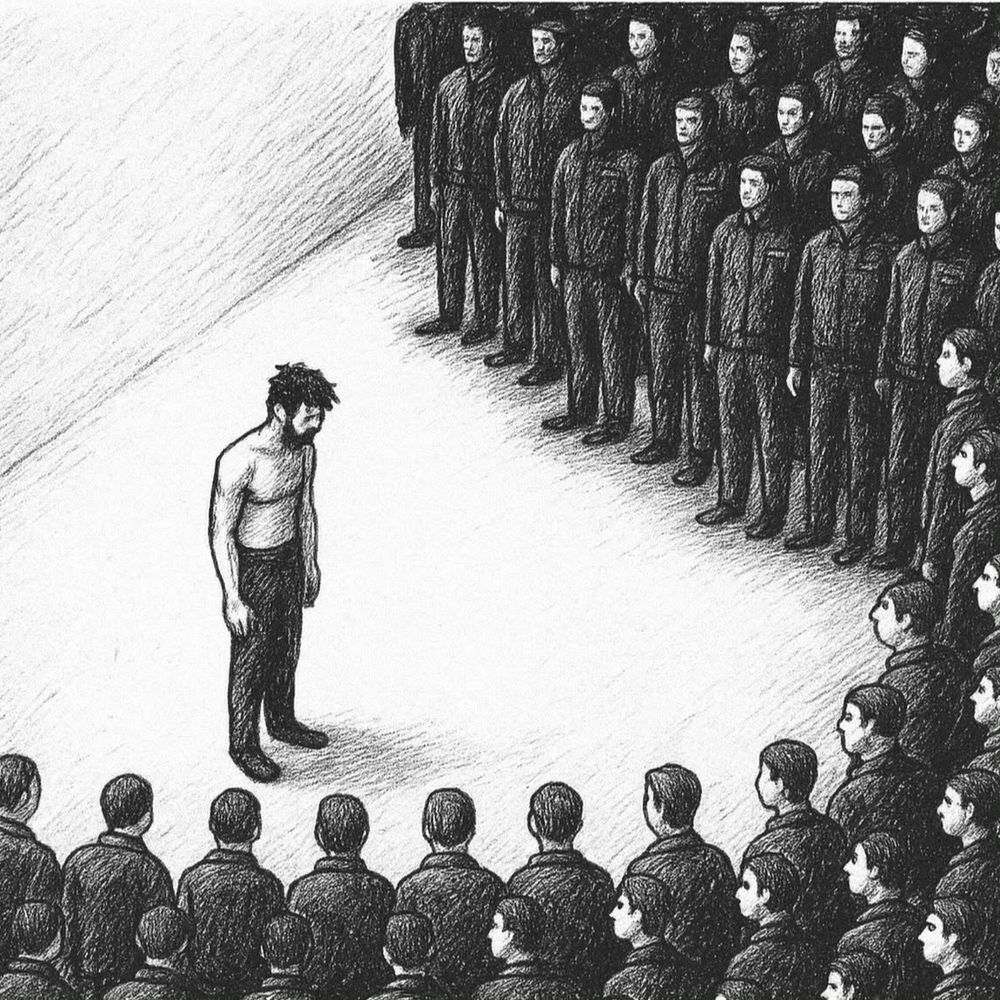 A man stands alone with his shirt off, surrounded by a larger group of other men, dressed in uniform - to symbolize the group's power over the individual.