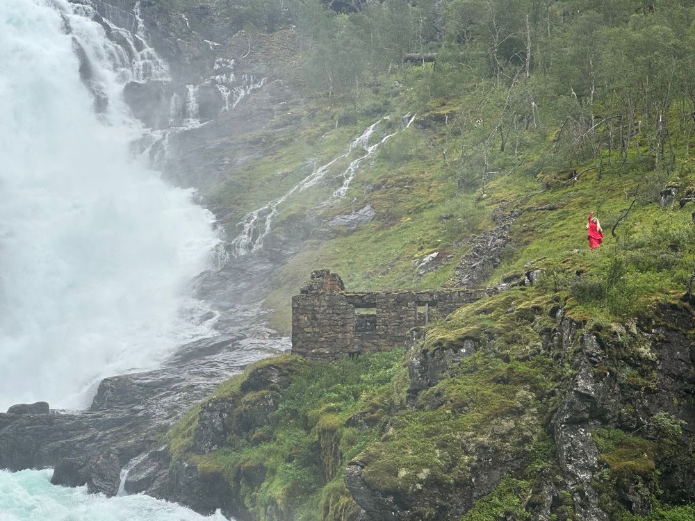 Lady in red dancing by the waterfall