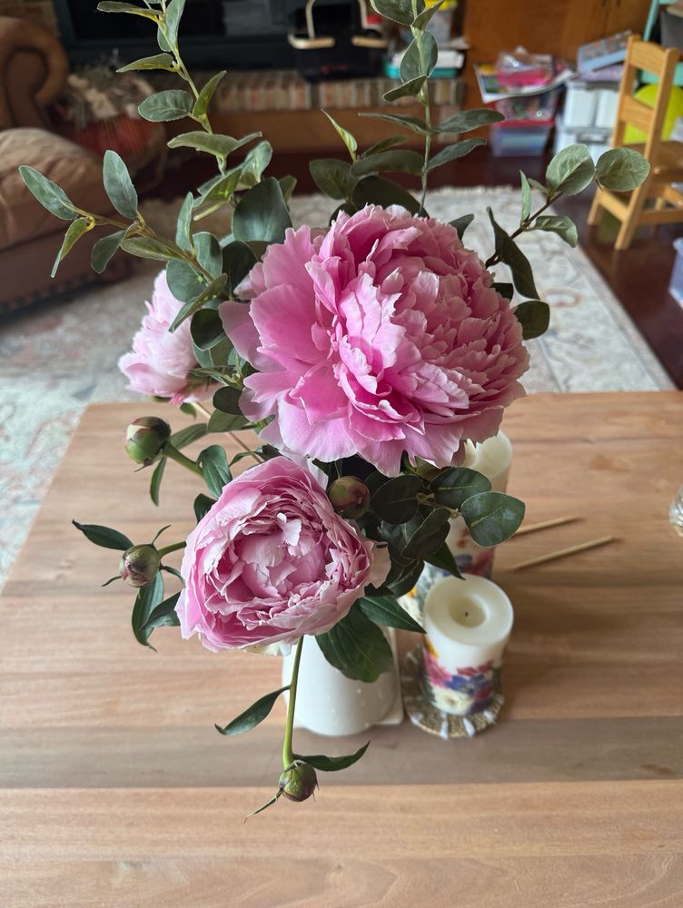 Peonies in a vase with fake eucalyptus leaves because we don’t try to do everything over here