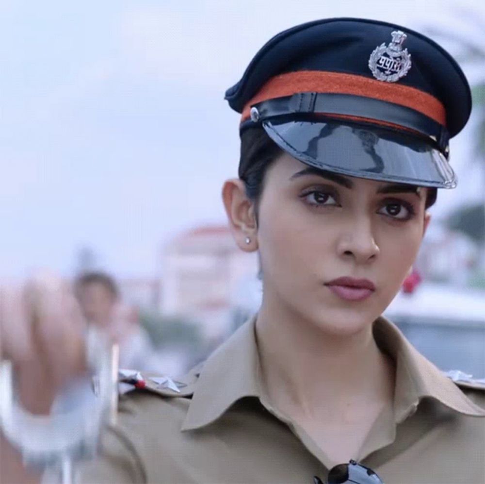 a woman in a police uniform with a badge that says ' delhi ' on it