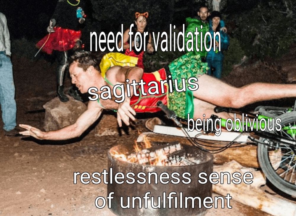 A flash photo of a campground with onlookers gawking as a man tumbling off his bicycle, inches from falling into a burning fire pit. The man is labeled "sagittarius", the bicycle "being oblivious", the gawkers "need for validation", and the firepit "restless sense of unfilfilment". 