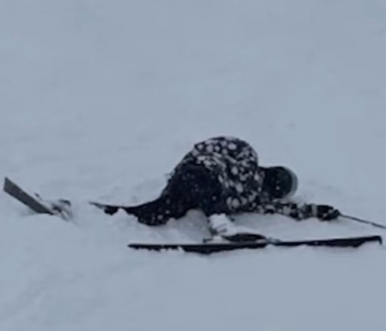 Daniel Howell laid in the snow after wiping out while skiing 

