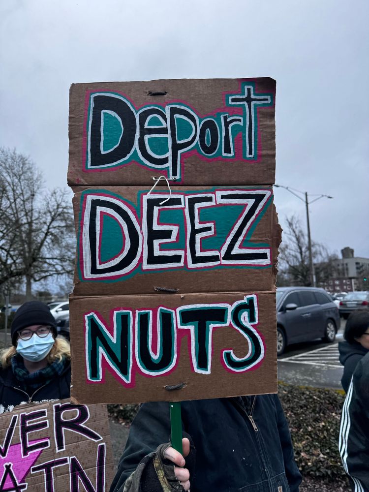 A sign reading "Deport Deez Nuts"