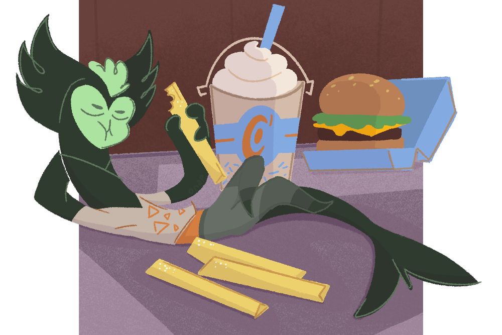 A picture of Boone, a small cat like alien with a shark tail eating French fries in front of a hamburger meal.