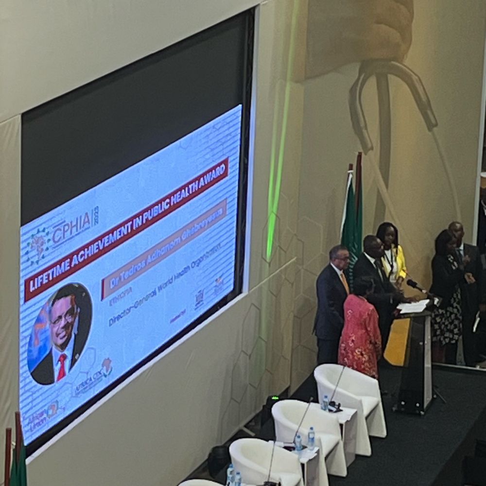 Tedros being awarded a lifetime achievement award by the DG of Africa CDC