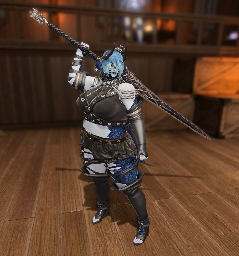 My Xaela WOL Zaya wears a strappy black outfit consisting of a crop top and shorts, with lots of chains and belts. She wields an iron greatsword.